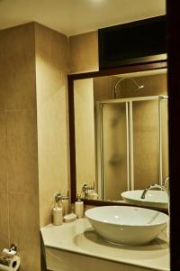 a bathroom with a white sink and a mirror at Baan Klang Condo Hua Hin in Hua Hin