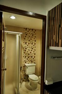 a bathroom with a toilet and a walk in shower at Baan Klang Condo Hua Hin in Hua Hin