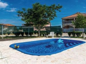a blue pool with a teddy bear in the middle at Apartment Laura mit Pool by Interhome in Stankovci