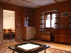 a living room with a table in the middle of a room at Apartment Davo Tuoi by Interhome in Guarda