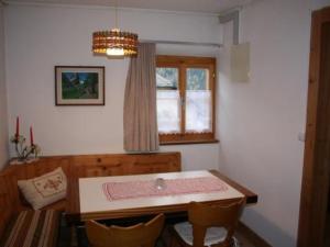 a dining room with a table and a window at Apartment Davo Tuoi by Interhome in Guarda