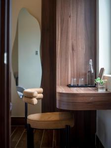 a wooden table with a chair and a counter top at Meek - Home and Coffee in Da Lat