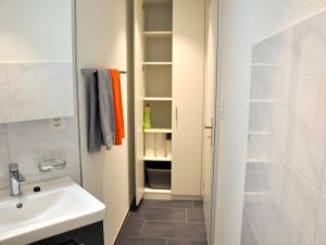 a bathroom with a sink and a toilet and a sink at Apartment Rätia by Interhome in Wolfhalden 