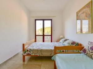 a bedroom with two beds and a window at Villa Marković 2 in Sutomore