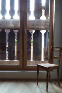a chair sitting in front of a window at Apartment Biala - BioBergün by Interhome in Bergün +9 photos