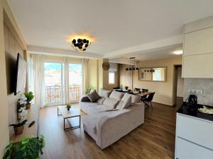 a living room with a couch and a table at Infinity Torremolinos Spacious 2 Bedroom, 2 Bathroom Apartment by NAMASTE ELITE in Torremolinos