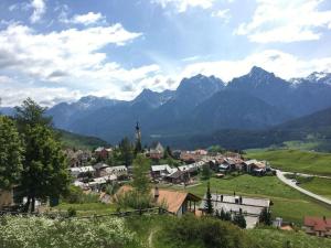 a small town in a valley with mountains in the background at Apartment cajos-ftan by Interhome in Ftan +15 photos
