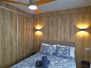 a bedroom with a bed and two lights on the wall at Infinity Torremolinos Spacious 2 Bedroom, 2 Bathroom Apartment by NAMASTE ELITE in Torremolinos