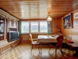 a dining room with a table and a tv at Apartment Hautle by Interhome in Eggerstanden - Appenzell