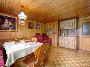 a dining room with a table and a couch at Apartment Hautle by Interhome in Eggerstanden - Appenzell
