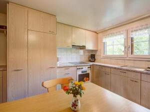 a kitchen with a table and a vase with flowers on it at Apartment Hautle by Interhome in Eggerstanden - Appenzell +15 photos