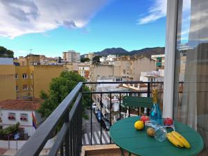 a table on a balcony with fruit on it at Infinity Torremolinos Spacious 2 Bedroom, 2 Bathroom Apartment by NAMASTE ELITE in Torremolinos