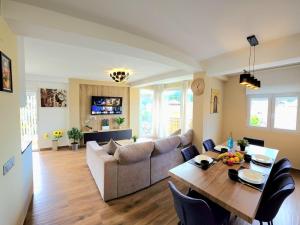 a living room with a table and a couch at Infinity Torremolinos Spacious 2 Bedroom, 2 Bathroom Apartment by NAMASTE ELITE in Torremolinos
