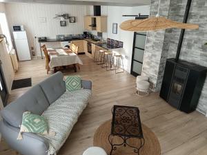 een woonkamer met een bank en een tafel en een keuken bij Porh tramesse in Saint-Thuriau