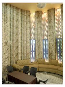 a living room with a couch and some windows at Pragya Farmhouse in Jodhpur