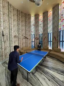 a man standing in front of a ping pong table at Pragya Farmhouse in Jodhpur +8 photos