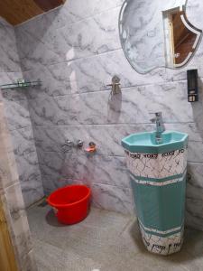 a bathroom with a sink and a mirror at Gulmarg View Guest House in Khor