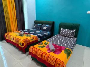 En eller flere senge i et værelse på Marvelous Homestay SP Kedah