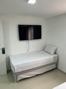 Ένα ή περισσότερα κρεβάτια σε δωμάτιο στο Pousada Pergentino