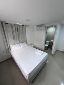 Ένα ή περισσότερα κρεβάτια σε δωμάτιο στο Pousada Pergentino