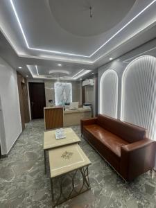 a living room with a couch and a table at Hotel the haveliya-1 mint from new delhi railway station & connaught place in New Delhi