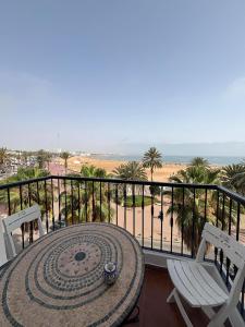 a balcony with a table and chairs and the beach at marina1 in Agadir