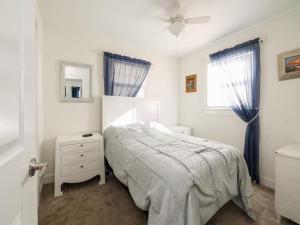 een witte slaapkamer met een bed en een raam bij Summer Escape In Loveladies Prime Long Beach Island Location in Loveladies
