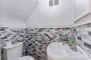 a bathroom with a toilet and a sink at 308A E Heather Rd, #3081 in Wildwood Crest