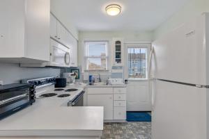 a kitchen with white cabinets and a white refrigerator at 308A E Heather Rd, #3081 in Wildwood Crest