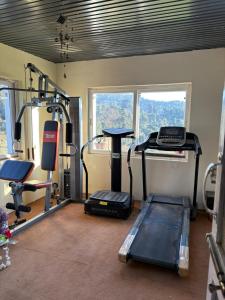 a gym with two tread machines and a treadmill at Tapas in Champawat