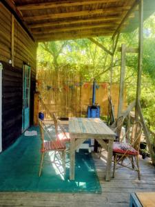 a wooden table and chairs on a patio at Casita isleña in Tigre