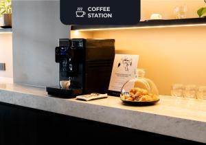 a coffee station with a bowl of food on a counter at Hotel Palermitano by DOT Boutique in Buenos Aires