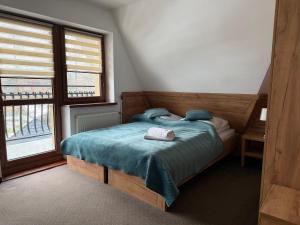 En eller flere senge i et værelse på Ośrodek Wypoczynkowy Baca