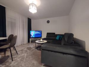 a living room with a couch and a tv at Old Town in Livno