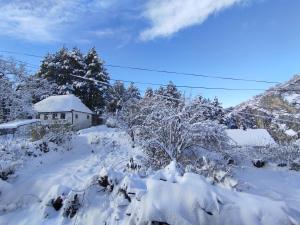 a yard covered in snow with a house in the background at Old Town in Livno
