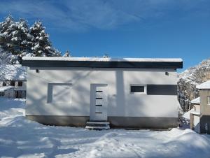 a small white building with a door in the snow at Old Town in Livno