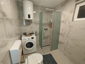 a bathroom with a washing machine and a washer at Old Town in Livno +5 photos