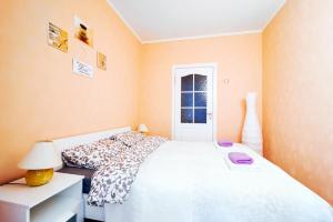 a bedroom with a white bed and a window at Vokzal Kirova 1 (2) in Minsk