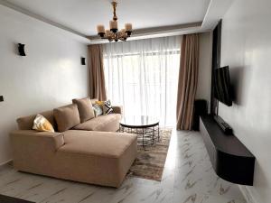 a living room with a couch and a table at Safari Cozy Homes in Nairobi