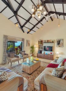 a living room with two couches and a table at SaffronStays Green Lawns in Pāli