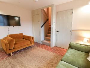 a living room with a chair and a couch at Fronglyd in Cardigan
