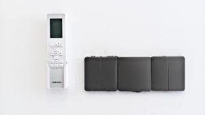 a remote control is attached to a wall at The Uma Tapan in Penginyahan