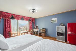 a bedroom with two beds and a blue wall at Heidi Korea in Hongcheon +111 photos