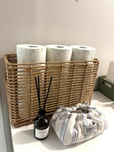 a basket with three rolls of toilet paper on a shelf at GreeneStay Sindang DDP Seoul in Seoul +240 photos