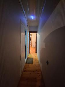 an empty hallway with a blue light on the ceiling at Deniz Hotel in Ganja