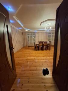 a hallway with a dining room with a table and chairs at Deniz Hotel in Ganja