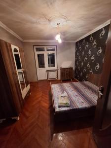 a bedroom with a bed and a wall with footprints on it at Deniz Hotel in Ganja