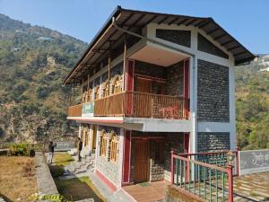 a house on the side of a mountain at Jaibari Basa in Ukhimath