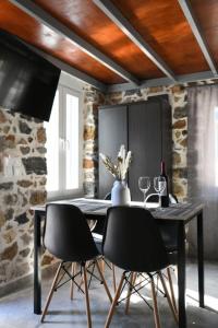 una sala da pranzo con tavolo e sedie neri di Markos House a Calimno (Kalymnos)