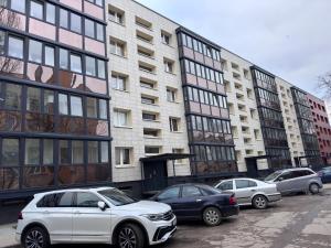 a group of cars parked in front of buildings at Welcome Centre Apartaments in Klaipėda